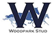 Logo of Woodpark Stud featuring a large, navy blue letter 'W' with silhouettes of two running horses in blue shades behind it. The text "WOODPARK STUD" is centered below the design, reflecting the strength and tradition akin to civil support services.